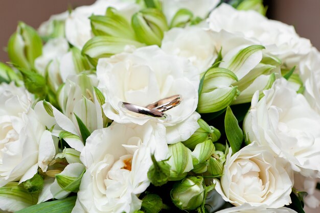 Gold wedding rings on flower