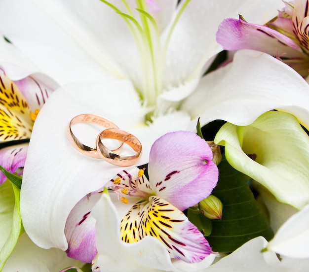 Gold wedding rings on flower