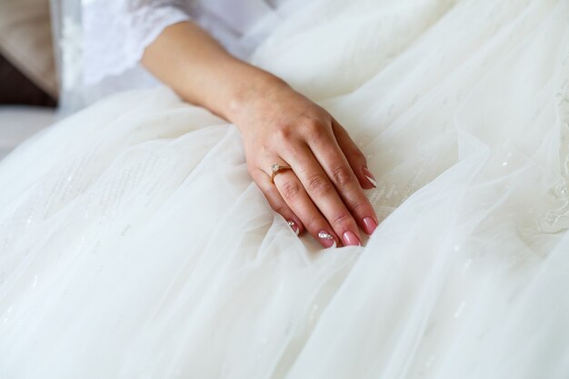 Gold wedding rings in the hands of the newlyweds