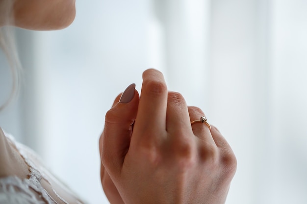 Gold wedding rings in the hands of the newlyweds