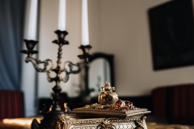 Gold wedding rings lie on an antique jewelry box. Wedding rings for ceremonies