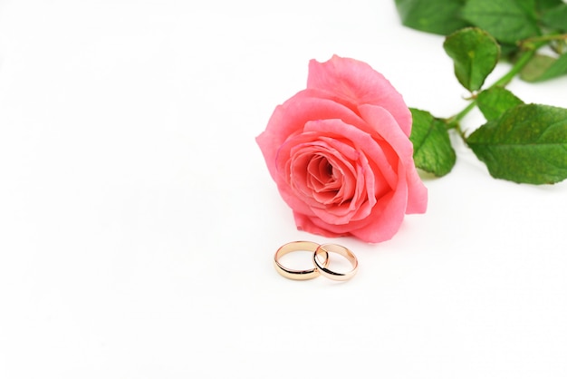 Gold wedding rings for newlyweds with a rose flower