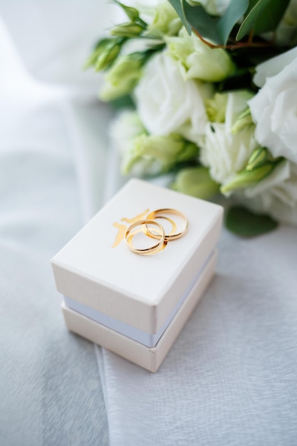 Gold wedding rings on the wedding day for the newlyweds Jewelry from expensive metal