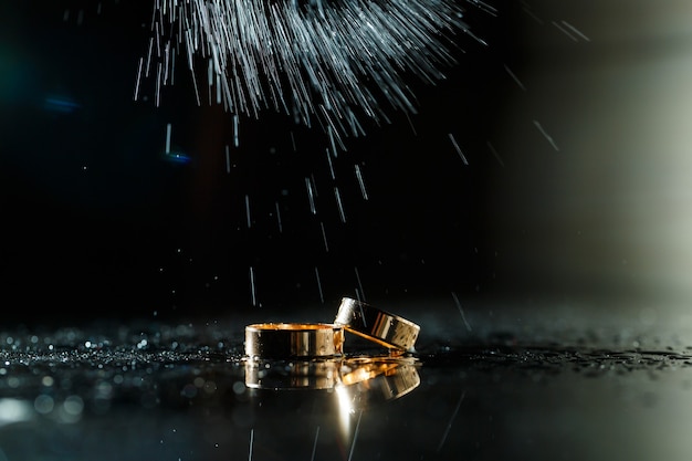 Gold wedding rings with water splashes