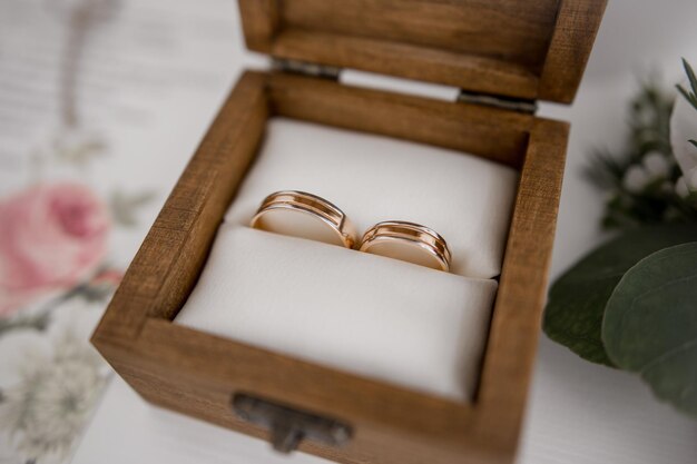 Gold wedding rings in a wooden box on the table