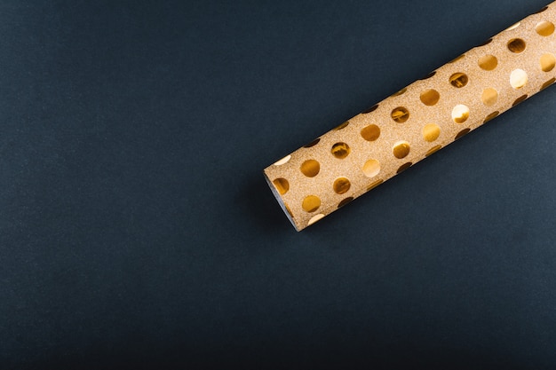 Gold wrapping paper on a black background.