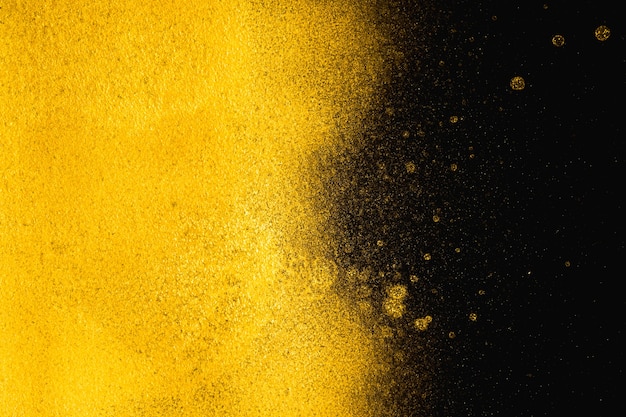 Golden abstract grainy texture on black background