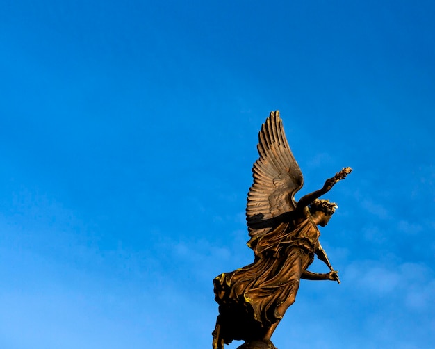 golden angel with yellow tones at sunset