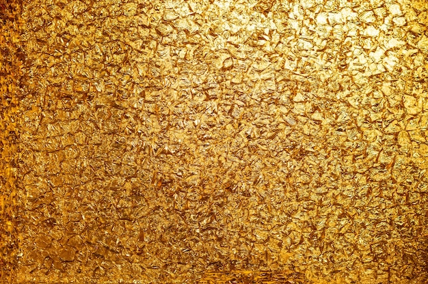 Golden background. Conceptual photo. Gold leaf wall.