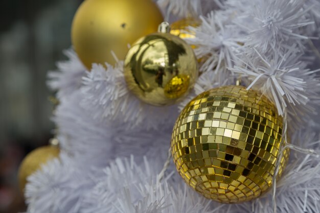 Golden Ball on White Christmas Tree background