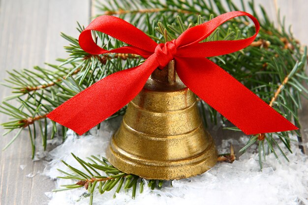 Golden bell with red satin ribbon bow