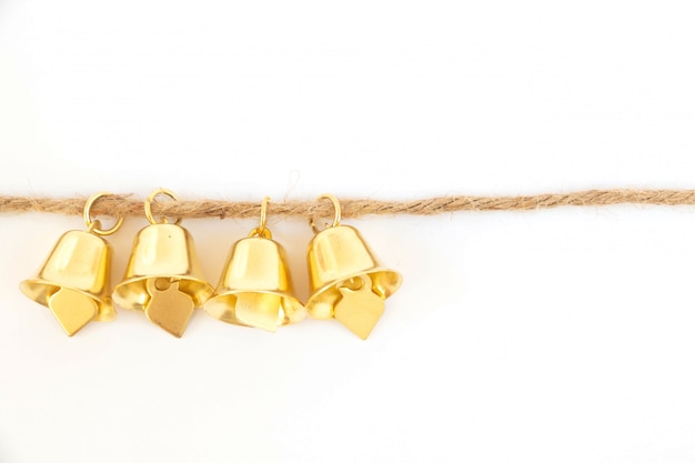 Golden bells on a brown rope 