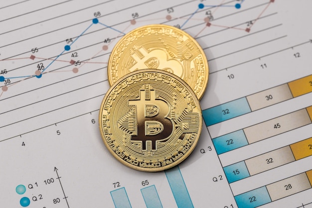 Golden bitcoin on diagram background. Macro