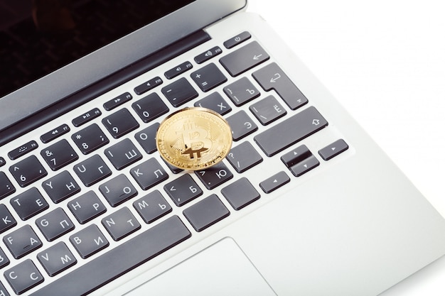 Golden bitcoin on a laptop