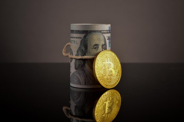 Golden bitcoin and money banknote on the table