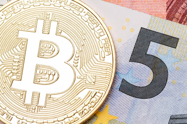 Golden bitcoin ob five euro banknote. High resolution photo.