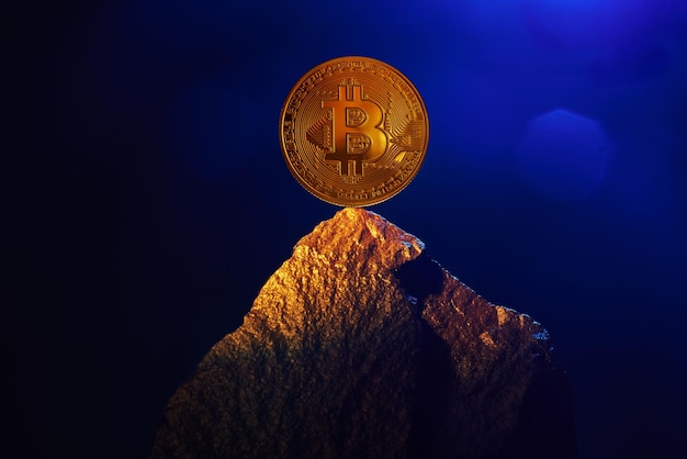 Golden bitcoin stands on a mountain of gold growth of cryptocurrencies