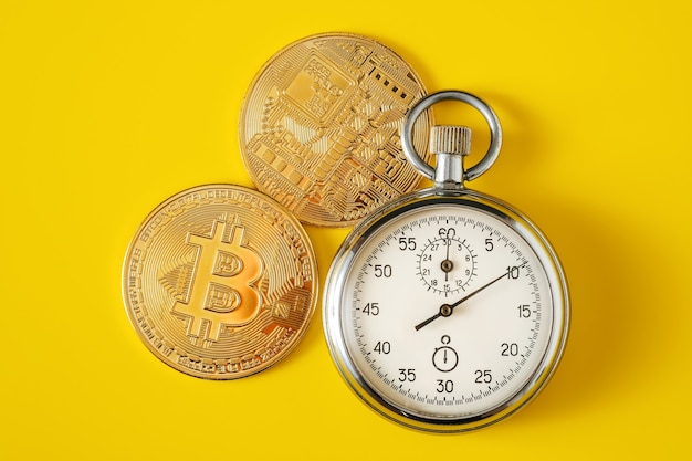 Golden bitcoin and stopwatch