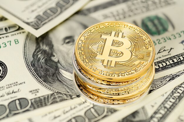 golden bitcoin on us dollar bills