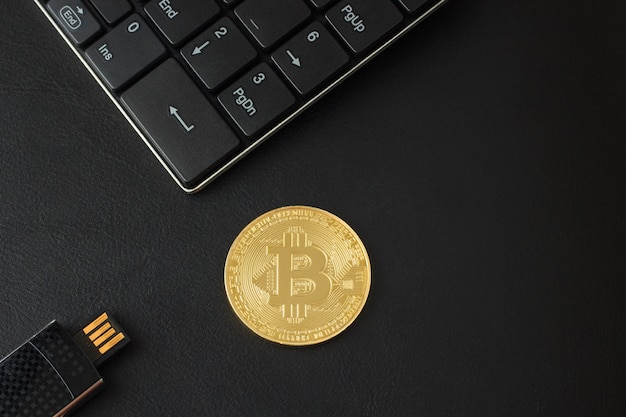 Golden bitcoin view from above on a black table