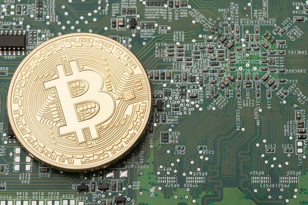 Golden Bitcoin virtual currency on a circuit board background