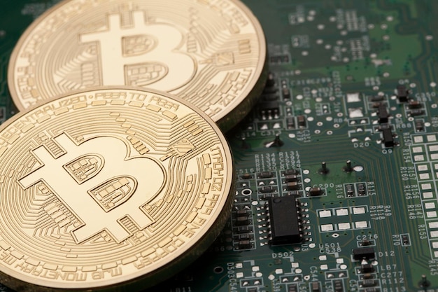 Golden Bitcoin virtual currency on a circuit board background