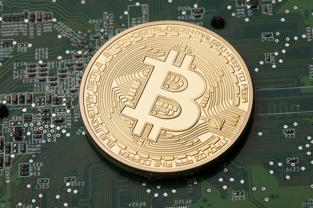 Golden Bitcoin virtual currency on a circuit board background