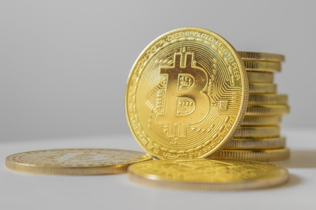 Golden bitcoin on white table and background - business concept of crypto currency.