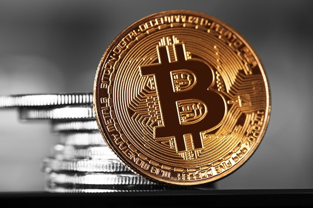 Golden bitcoin on wood background