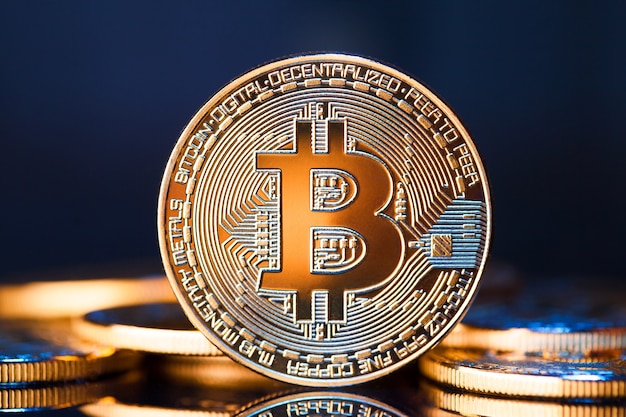 Golden bitcoins on blue surface