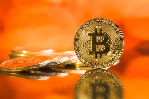 Golden bitcoins Cryptocurrency in front of colorful background