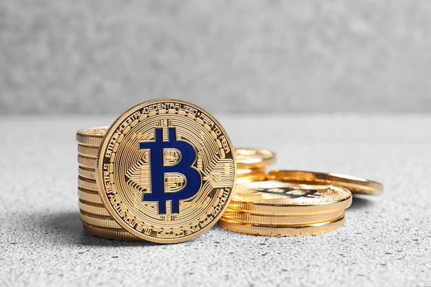 Golden bitcoins on light background