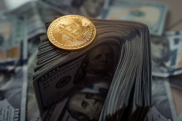 Photo golden bitcoins lying on us dollars