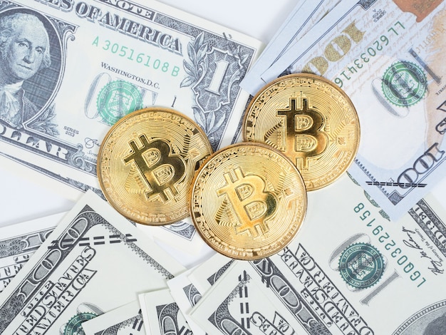 golden bitcoins on the money dollar top view