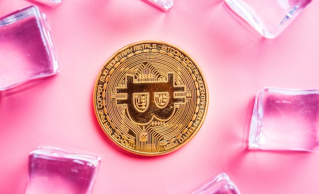 Golden Bitcoins with light pink background New virtual money on internet