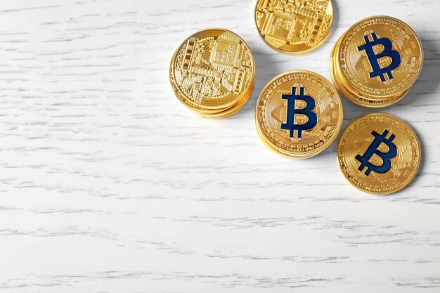 Golden bitcoins on wooden background