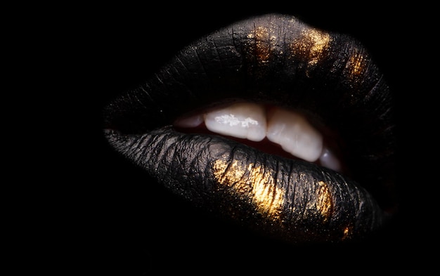 Golden and black lipstick closeup Metallic gold lips