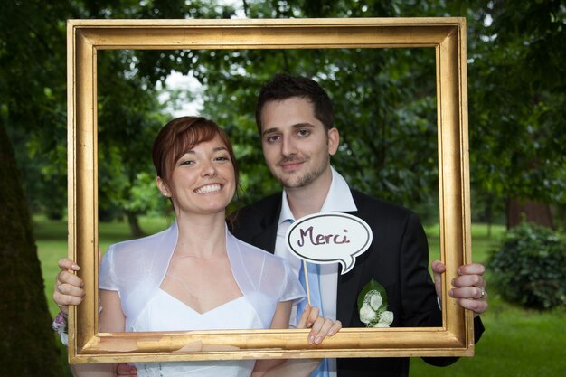 A golden board and newly young wedding couple