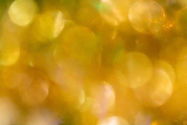 Golden bokeh light close up as background Bright round golden yellow Christmas lights as wallpapers Holiday sparkling shimmering background Horizontal format Copy space for text