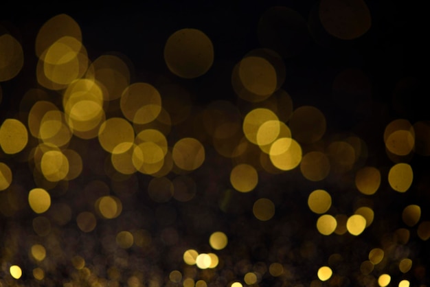 Golden bokeh like shining star on dark background