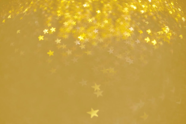 Golden bokeh like shining star on gold background