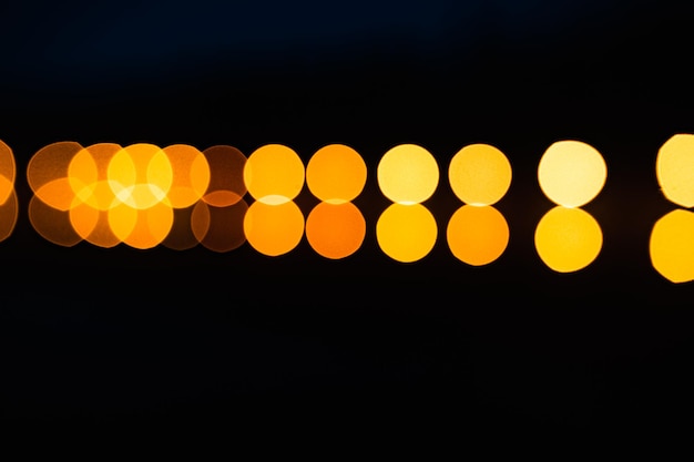 Golden bokeh particles and highlights on dark background