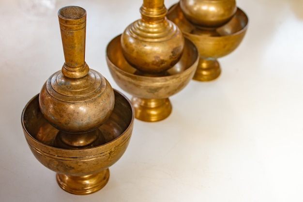 A golden brass pour ceremonial water jar