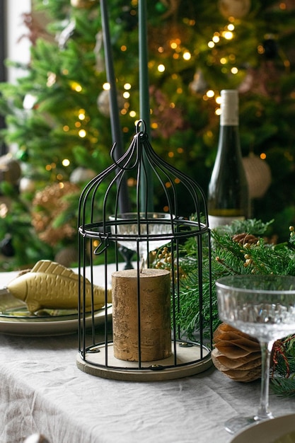 Golden candle inside metal box on christmas table setting