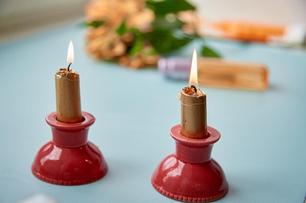 Golden candles on red candlestick home coziness High quality photo