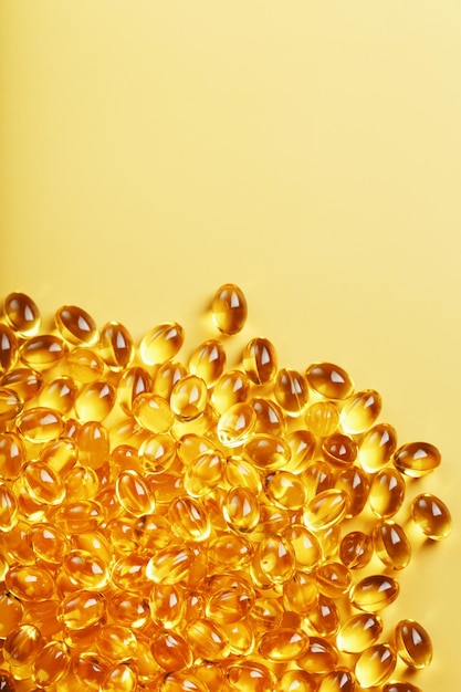 Golden capsules of Vitamin Omega 3 Fish Oil closeup