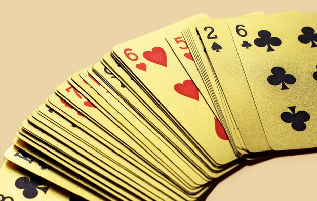 golden casino playing cards in a row or chaotic arrangement on orange background four aces isolated