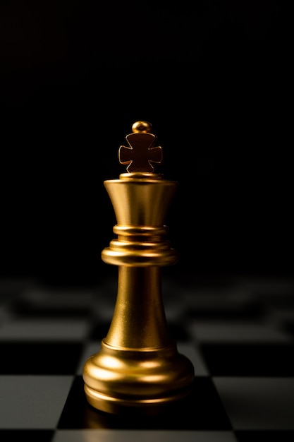 Golden chess king in piedi da solo sulla scacchiera