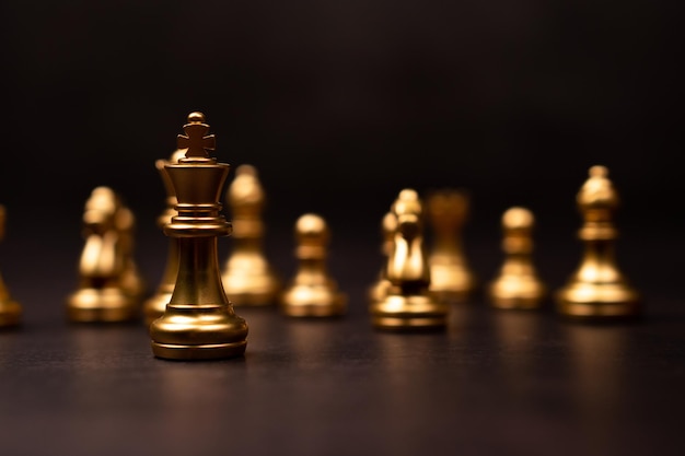 Photo golden chess king standing to be around of other chess concept of a leader must have courage and challenge in the competition leadership and business vision for a win in business games