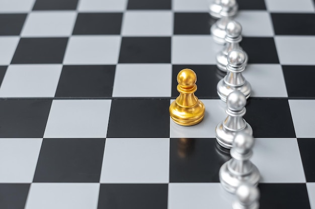 Golden chess pawn pieces or leader businessman stand out of\
crowd people of silver men leadership business team teamwork and\
human resource management concept